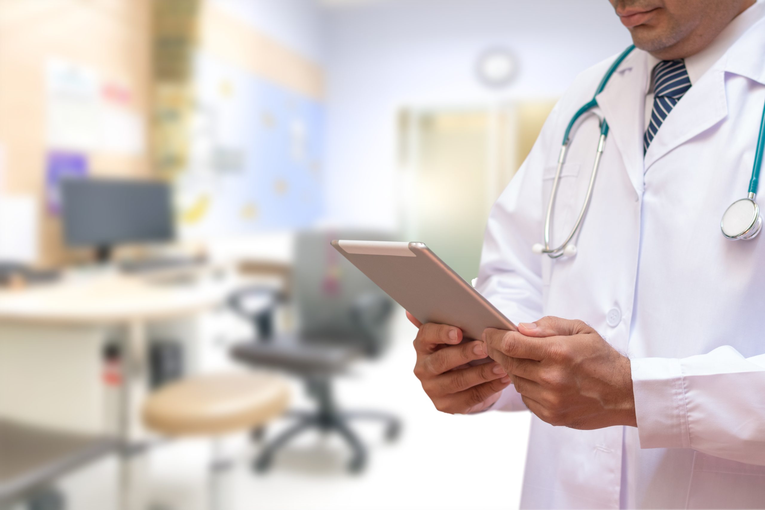 E-Health Doctor concept. Professional medical physician with stethoscope using tablet computer connecting with patient consulting in clinic hospital. Medical/ healthcare/ technology concept